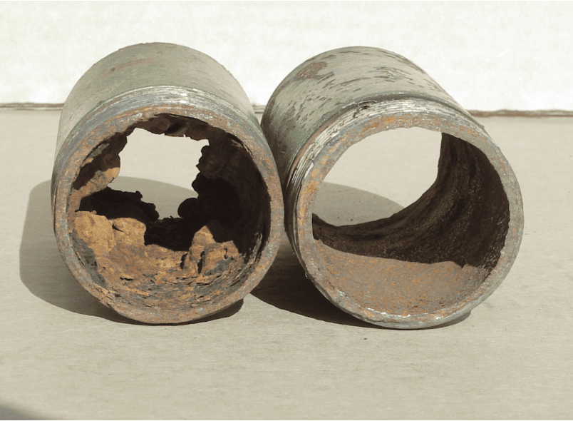 Corroded metal pipes with rust buildup and interior damage.